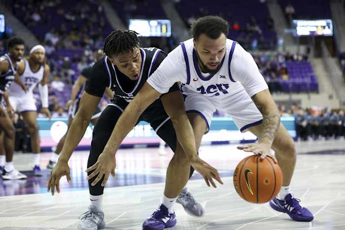 Dec 28, 2022; Fort Worth, Texas, USA; TCU Horned Frogs forward JaKobe Coles (21) and Central Arkansas Bears guard Camren Hunter (23) go for the ball during the first half at Ed and Rae Schollmaier Arena.